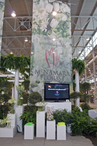 Exhibit booth banner used as centerpiece of booth design.